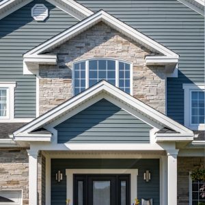 Stone siding added to an architectural area of the front of a home above the porch overhang around a curb facing window, in mission point colour.