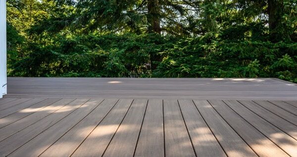 Composite-Deck-Deck-Installation-Deck-Construction-Service-In-Chatham-Kent-Ontario-Aurora-Exteriors-Inc Photo of a Back Deck Project, made from composite deck boards in Chatham-Kent Ontario with Wooded Area in the Background