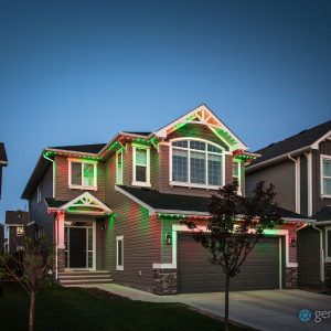 Elegant Red and Green Christmas Colours Displayed on a Modern Home using permanently installed Gemstone Lighting Solution