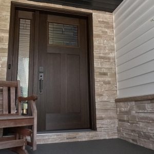 Stone Siding in a Sand Colour Applied Around the Entry Door of a Residential Home in Chatham-Kent, Providing a Stunning Accent Piece.