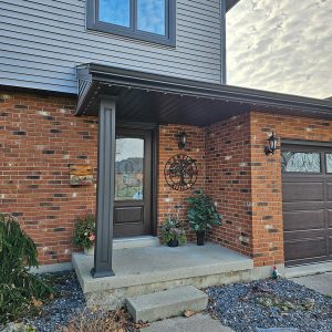Replacement Fiberglass front entry door, and dark column wrap installed by Aurora Exteriors Inc on Chatham Side Split Home