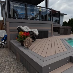 TruNorth Composite Deck with Black Aluminum Safety Railings and Glass Inserts on the upper level.