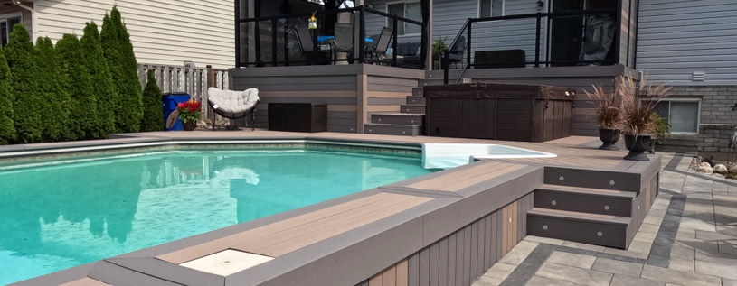 Beautiful custom multilevel composite deck with aluminum glass railings and built in gemstone deck lighting.