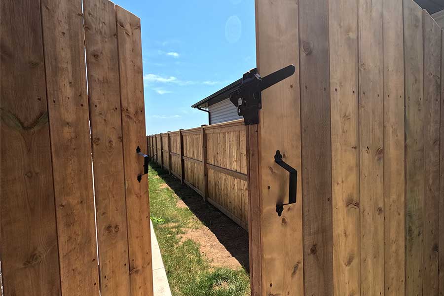 Open Fence Gate of Pressure Treated Wood with Beautiful Wood Grain Texture and Simple Black Gate Hardware