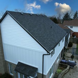 Left Side of a White Modern Farmhouse Style Home with White Board and Batten Siding and Cedar Shake Gable Accents Refaced by Aurora Exteriors Inc