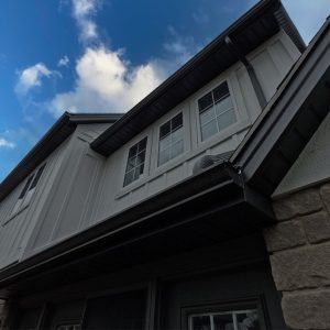Black Soffit on the Underside of a Porch Overhang on the Front of a Modern Farmhouse Style Home Refaced by Aurora Exteriors Inc.
