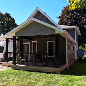 Full house view of a Covered Porch Addition and Exterior Reface Project completed by Aurora Exteriors Inc