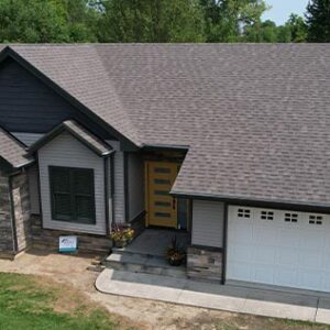 Overhead View of A Home After a Complete exterior makeover by Aurora Exteriors Inc, featuring stone siding accents in a dark Sterling colour and dark stonecrest grey vinyl siding with manor shakes in the gables.