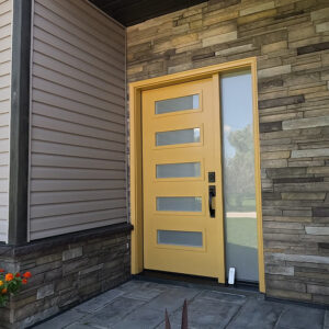 Modern, Bright, Autumn Yellow Entry Door with Sterling Versetta Stone siding Accents Around Porch Entryway.