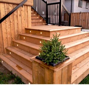 Gemstone Deck Lights Built Into the Stairs Of a Multi-tier Deck Built By Aurora Exteriors Inc.