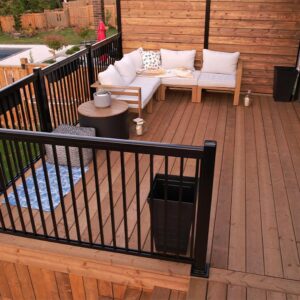 White Patio Furniture on the Upper Level of a Multi-tier Deck Built By Aurora Exteriors Inc.