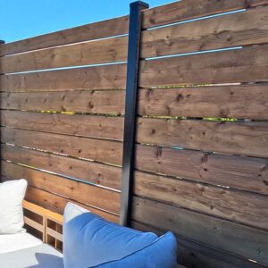 Pressure Treated Privacy Fence with Black Aluminum Posts on the Upper Level of a Multi-Tier Built By Aurora Exteriors Inc.